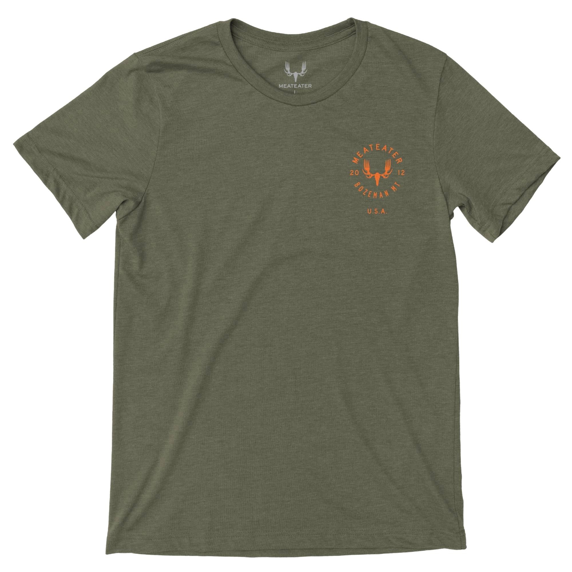 Military heather t-shirt with an orange MeatEater antler logo and "Bozeman, MT, U.S.A." text.
