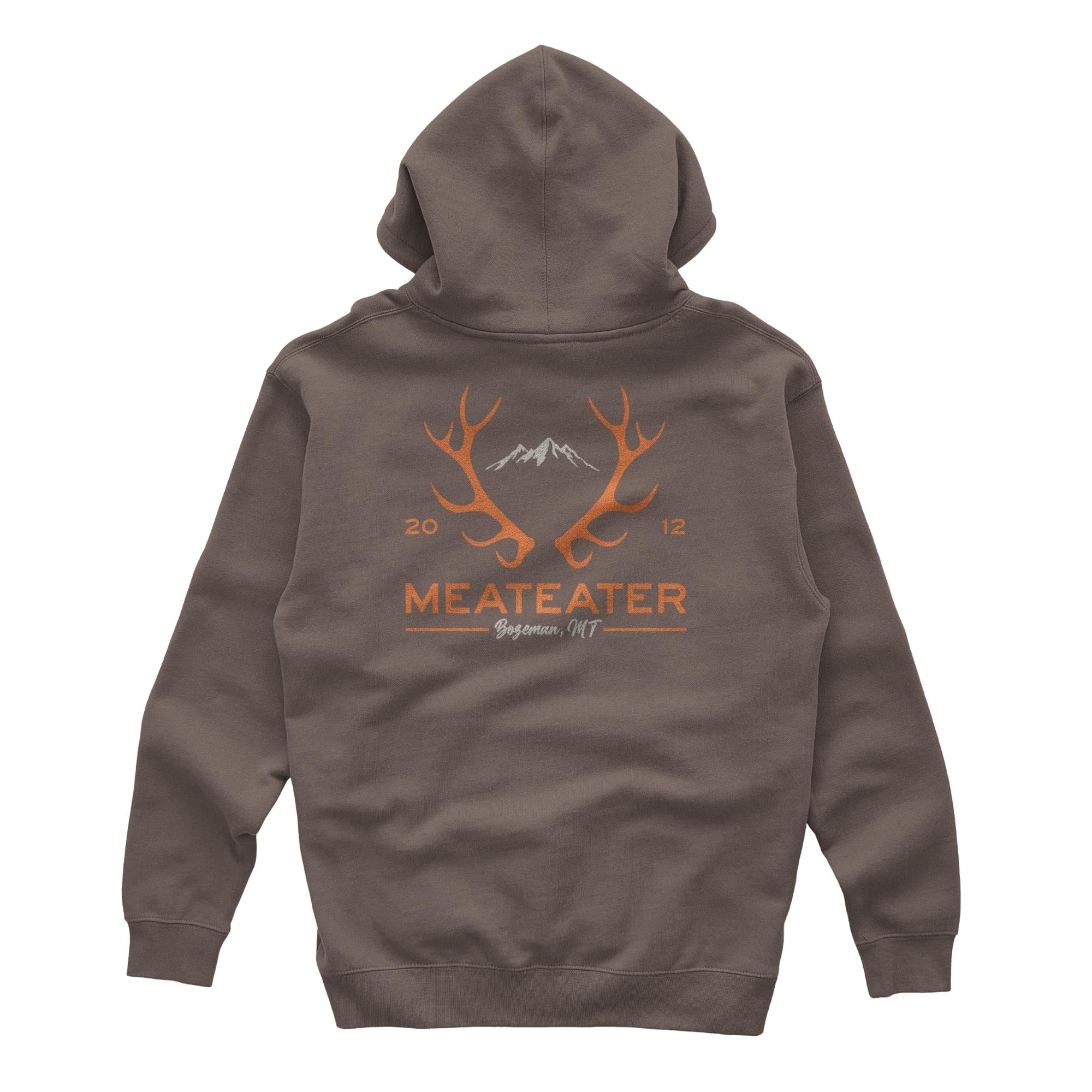 Brown hoodie with orange antler, white mountain, 'MEATEATER Bozeman, MT' back logo.