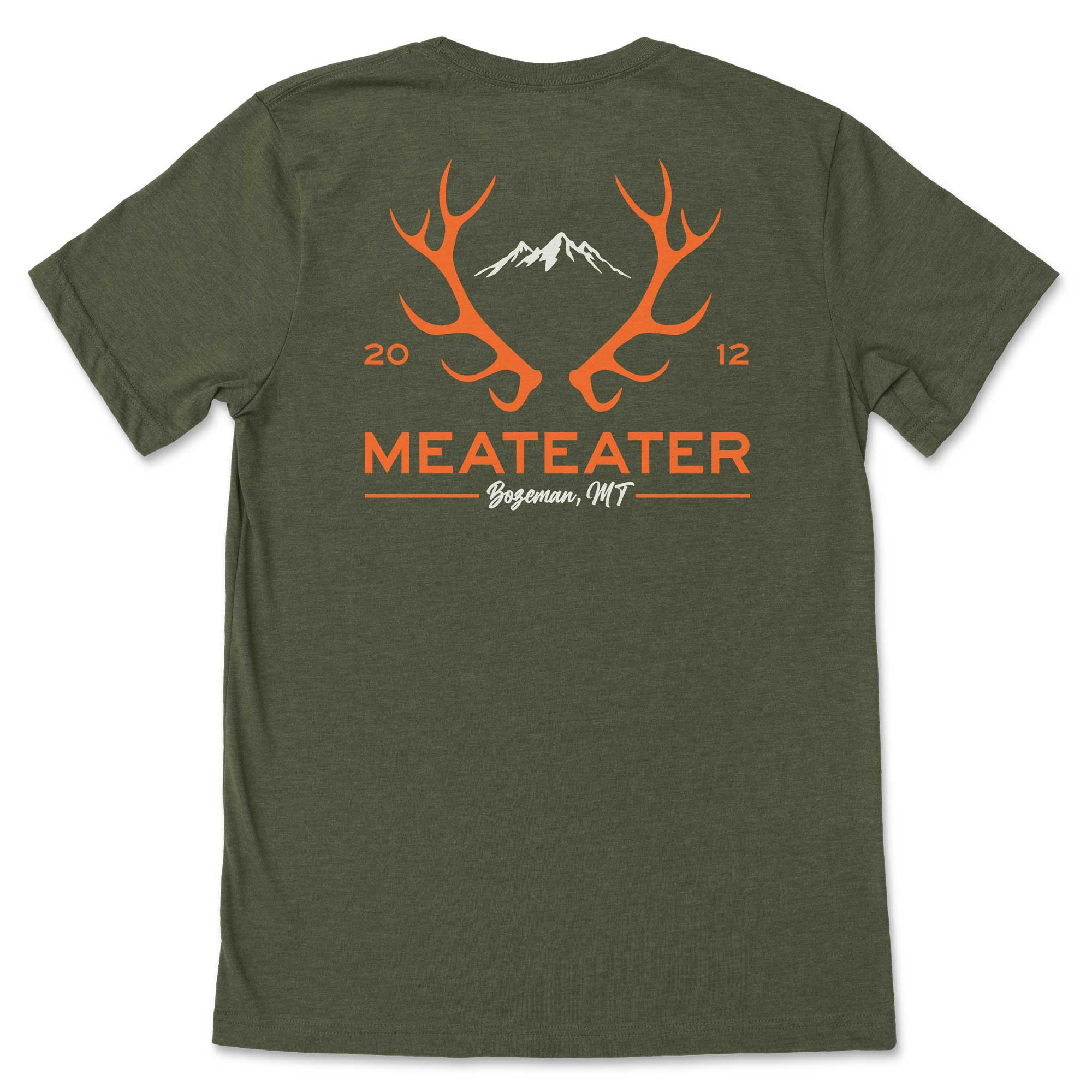 Olive green t-shirt with orange antlers, white mountains, "MEATEATER Bozeman, MT" (2012).