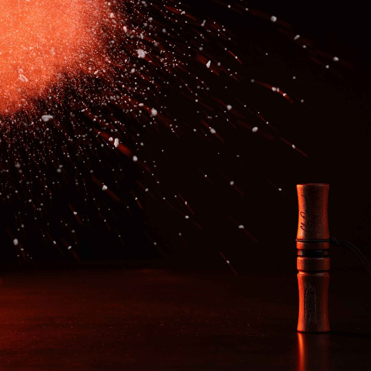 Akern MeatEater x Phelps deer call in a dark room facing a light burst.