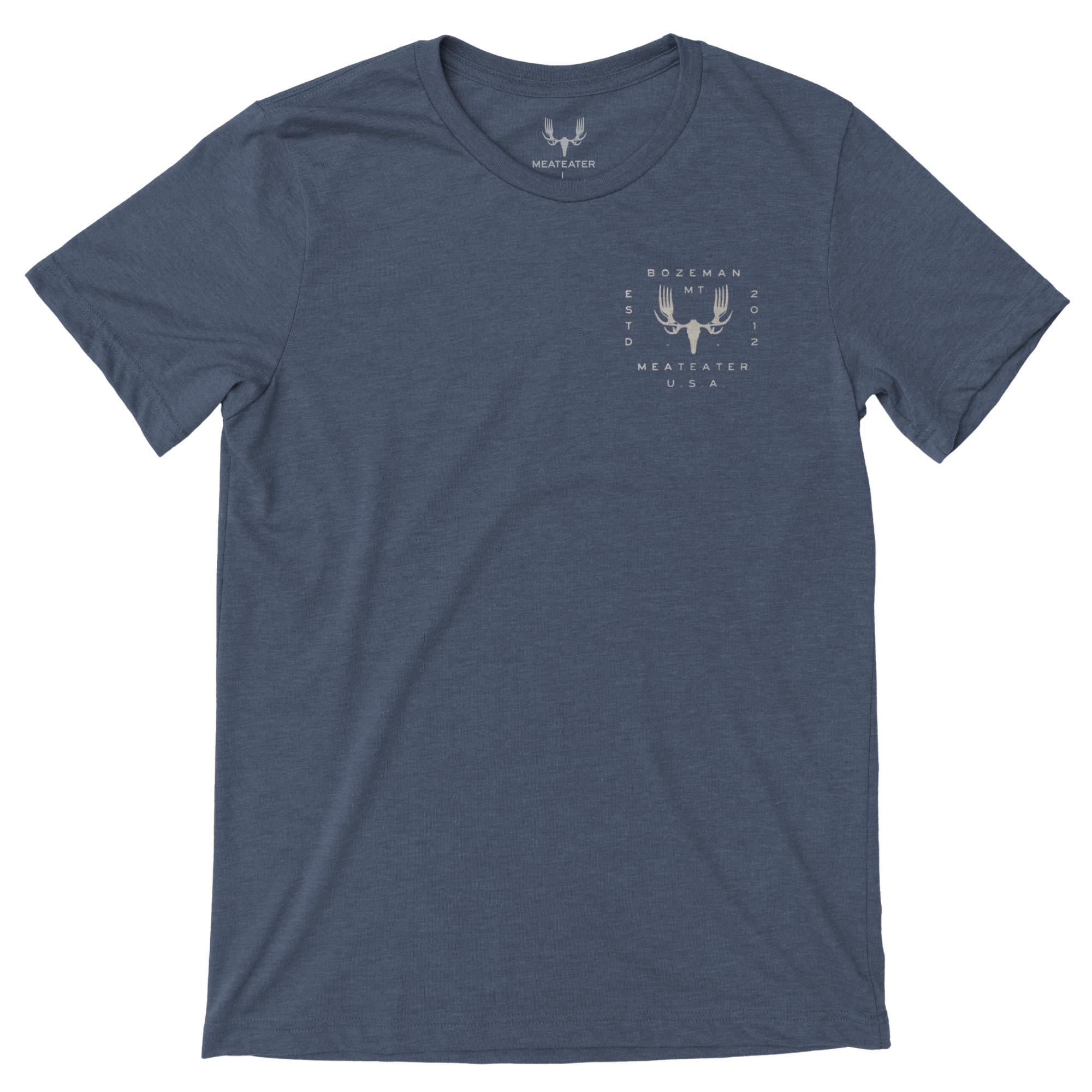 Navy heather t-shirt with a beige MeatEater fork-antler logo and text on left chest.