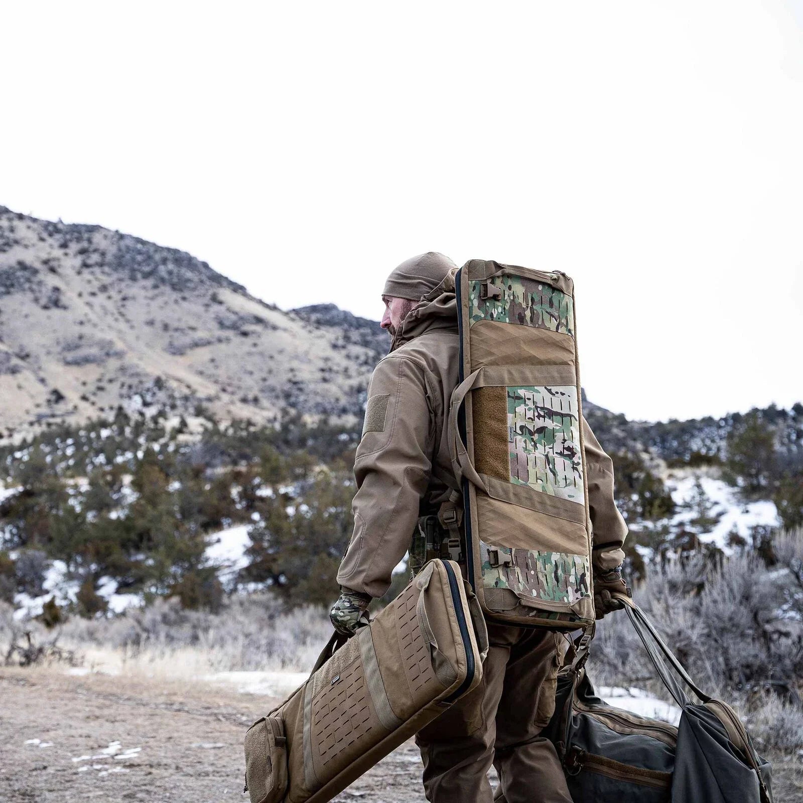Tan modular rifle pack with Multicam panels and laser-cut MOLLE on a person outdoors.