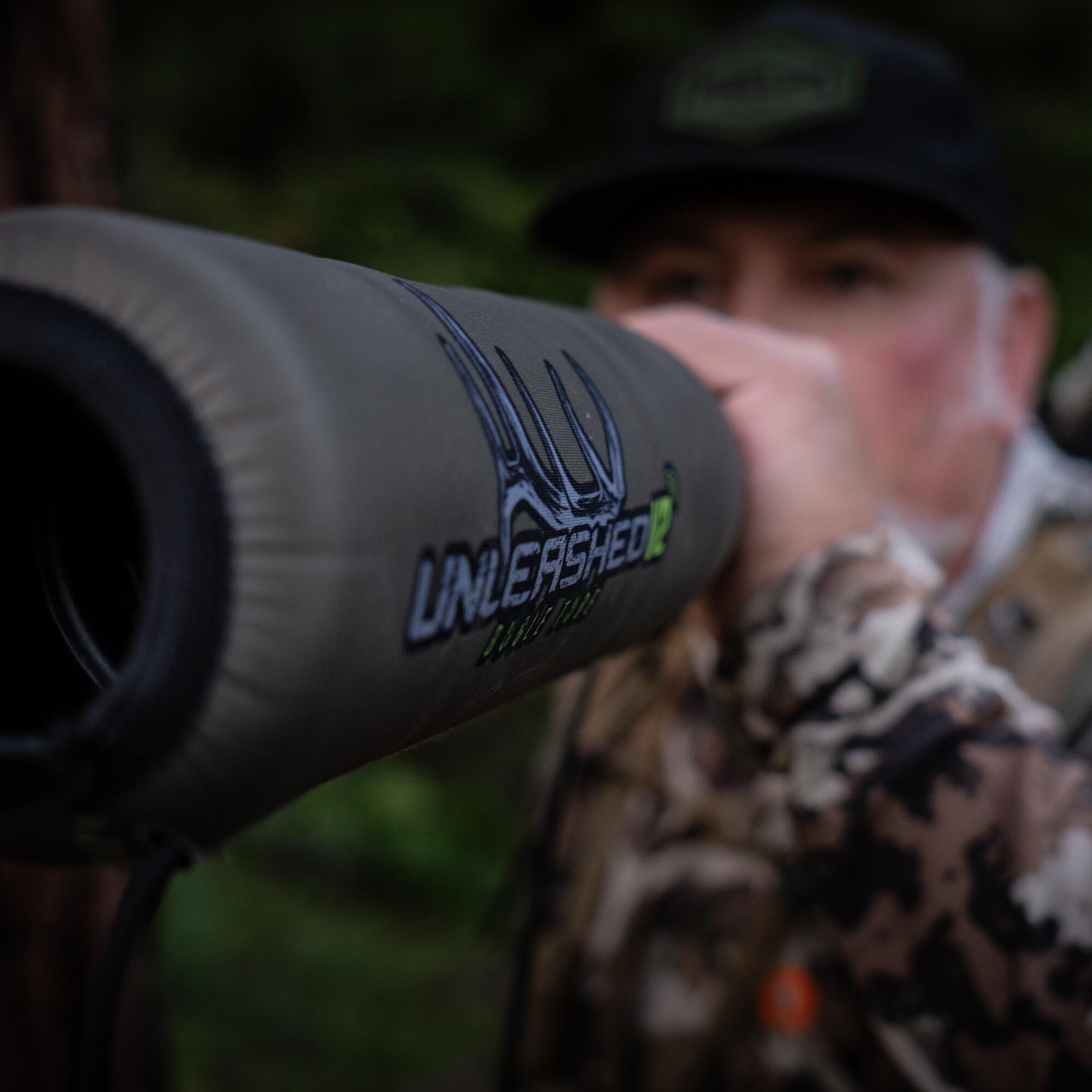 Olive green hunting game call with "UNLEASHED" text and antler logo.