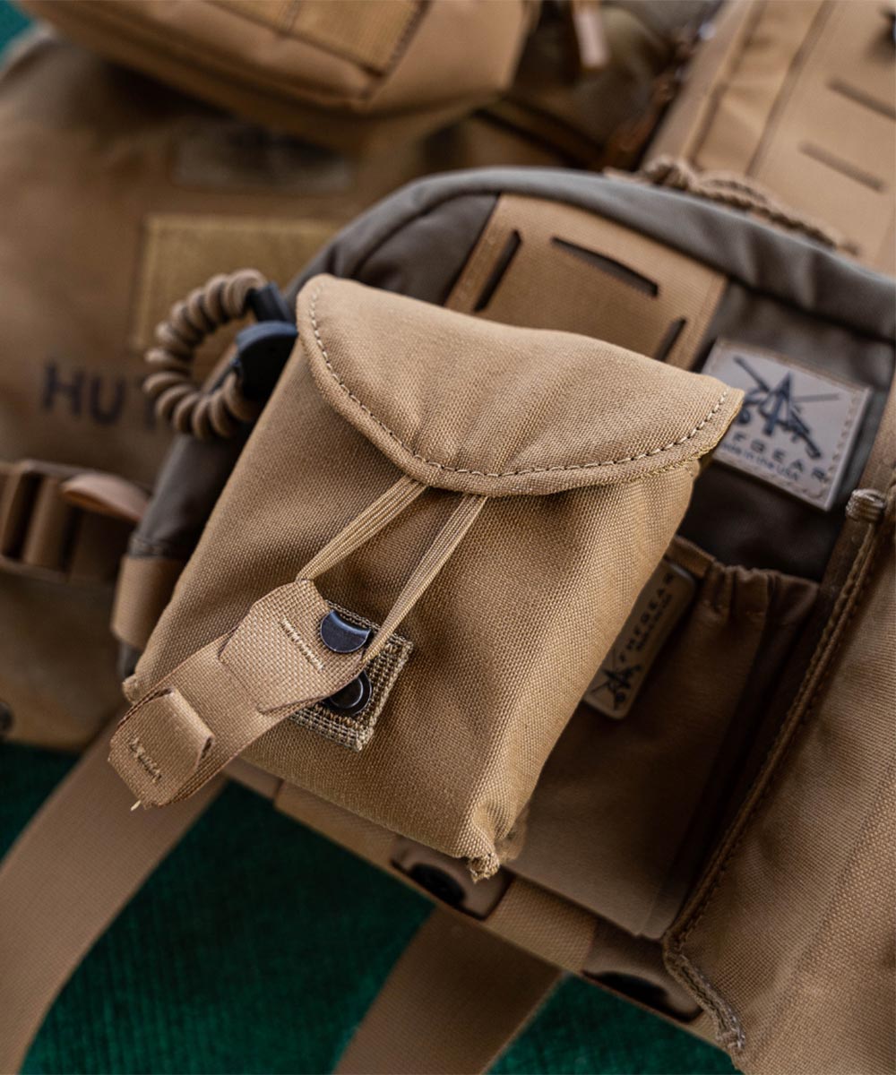 Coyote tan tactical utility pouch with a flap closure and bungee retention.