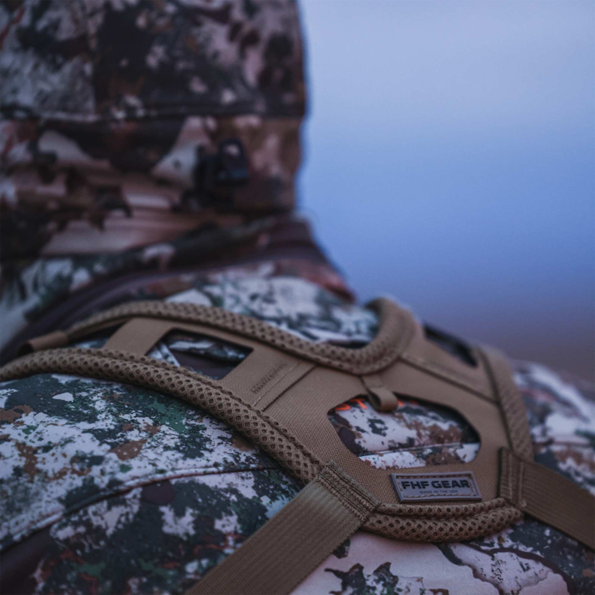 Tan FHF GEAR mesh-padded harness worn over a camouflage jacket.