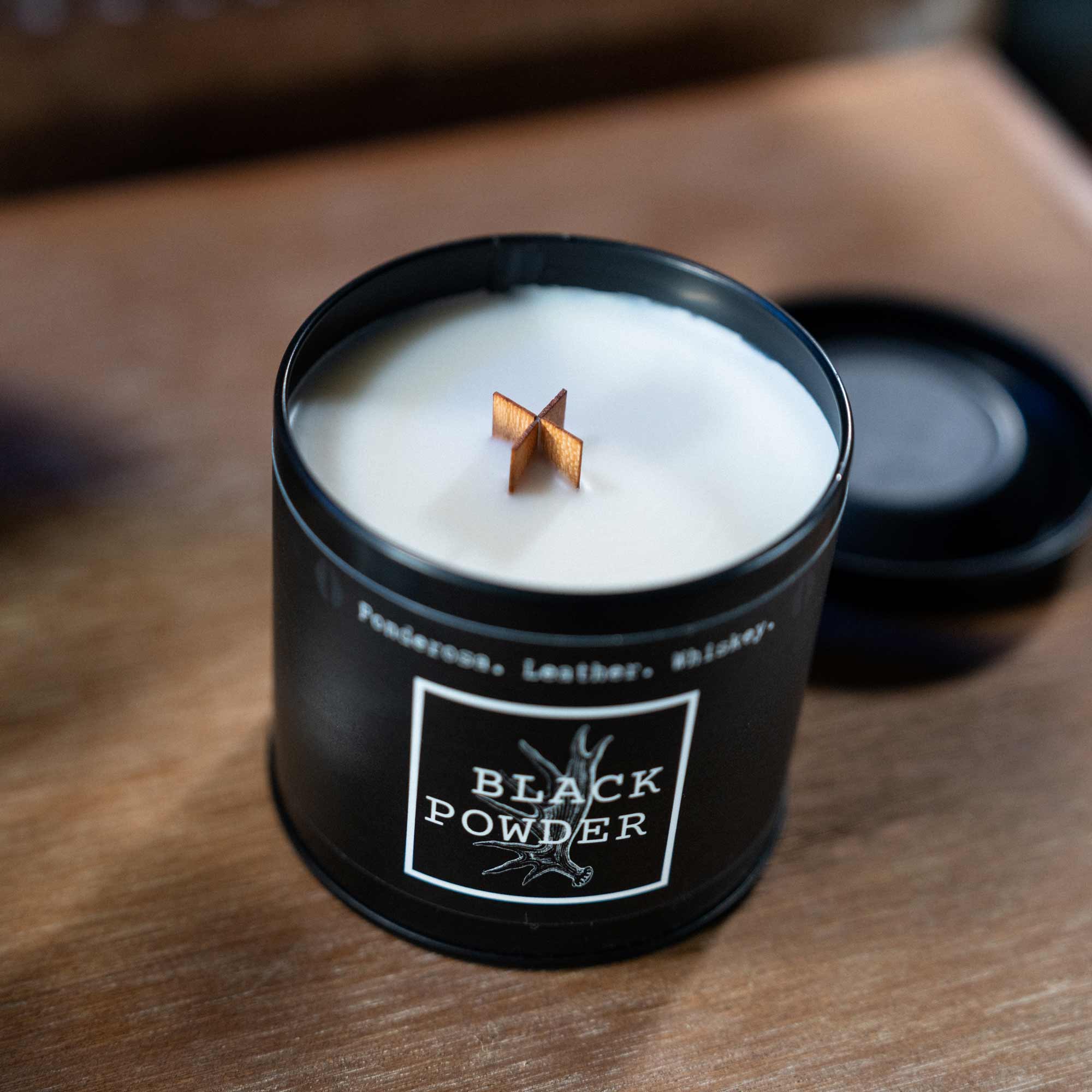 Black Powder candle with lid off showing wood wick. 