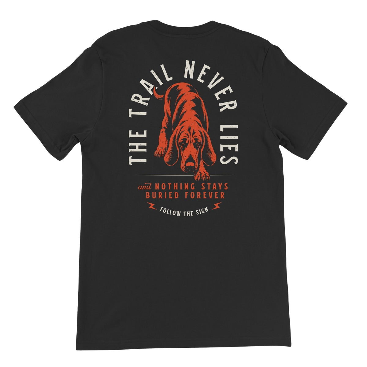 Black T-shirt featuring a red hound and light beige arched text "THE TRAIL NEVER LIES" above it, below there is red text "AND NOTHING STAYS BURIED FOREVER", beneath the text in beige "FOLLOW THE SIGN".