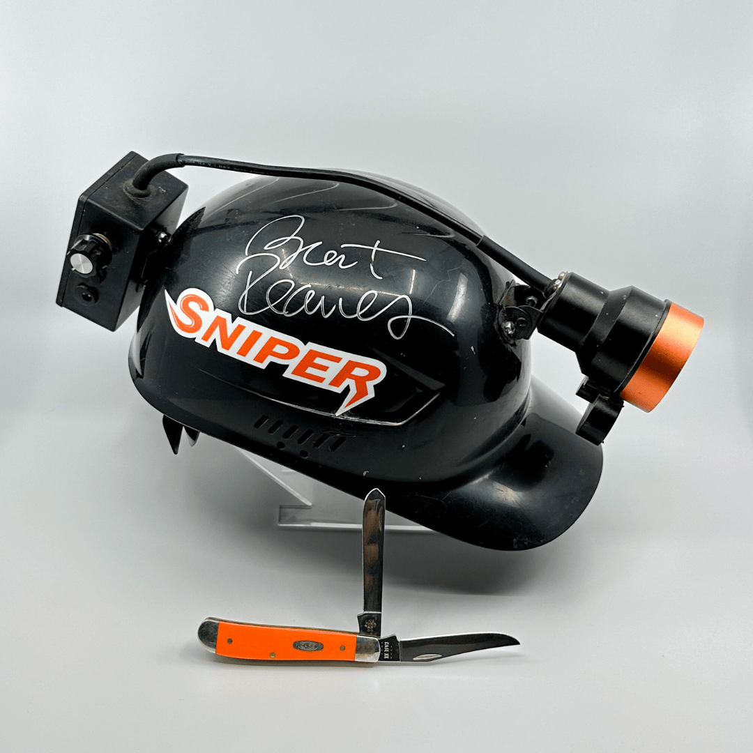 Black helmet with "SNIPER" logo, signature, headlamp with orange ring, and orange folding knife.
