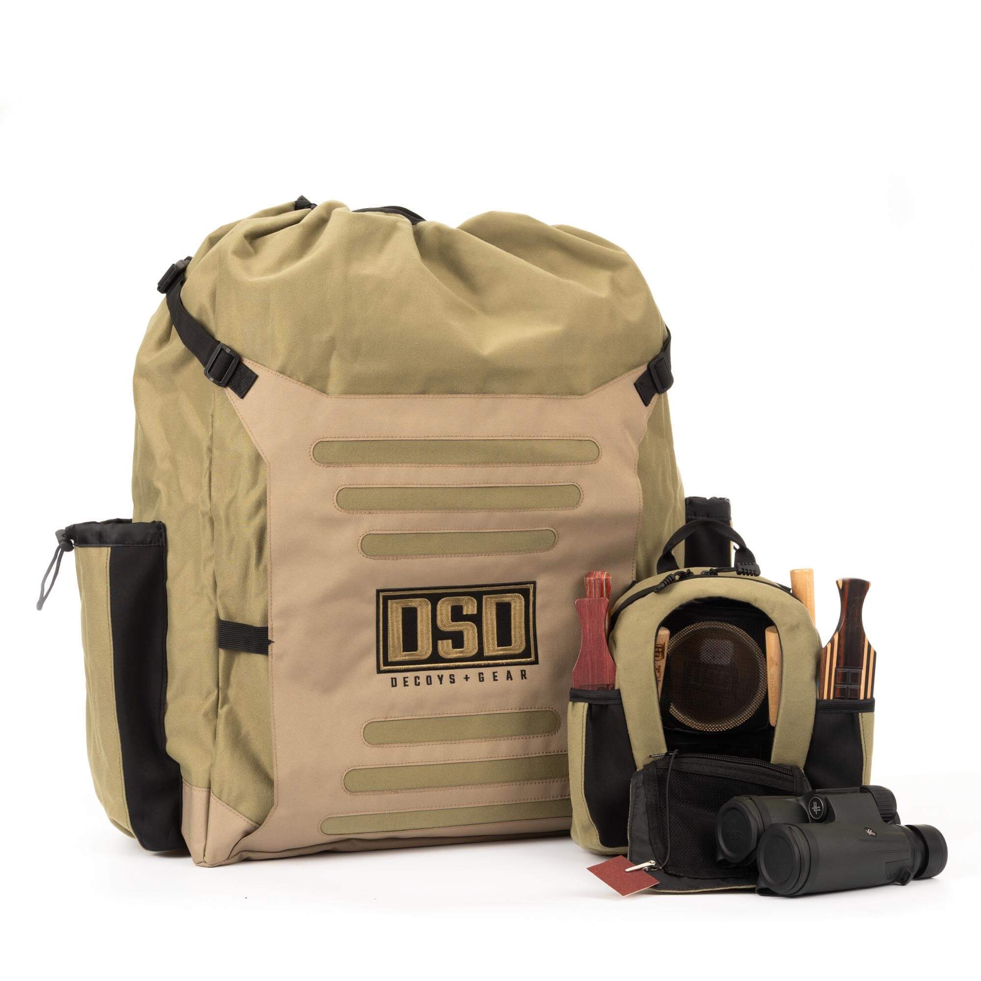 Khaki DSD backpack with molle straps, plus open gear bag with calls and binoculars.
