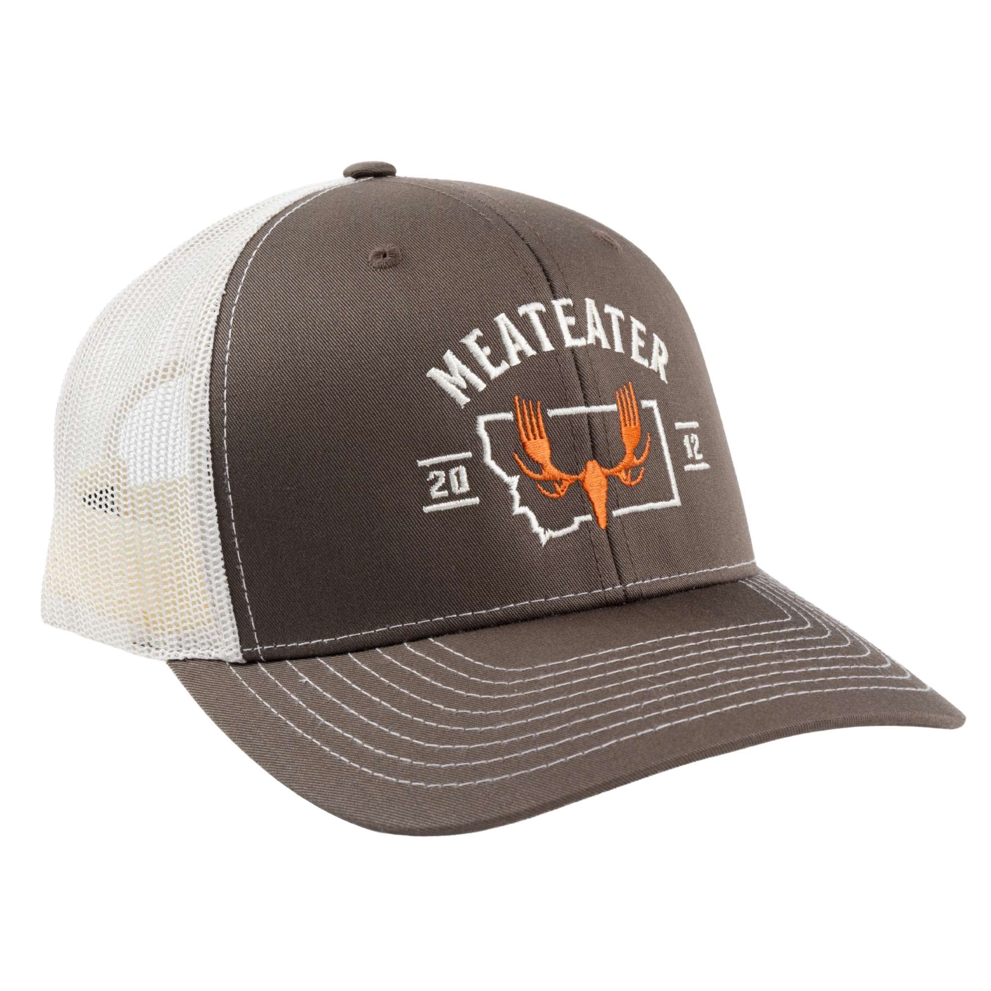 Brown and beige cap with a patch featuring MEATEATER logo in orange on top of a Montana map and text "MEATEATER 2012".