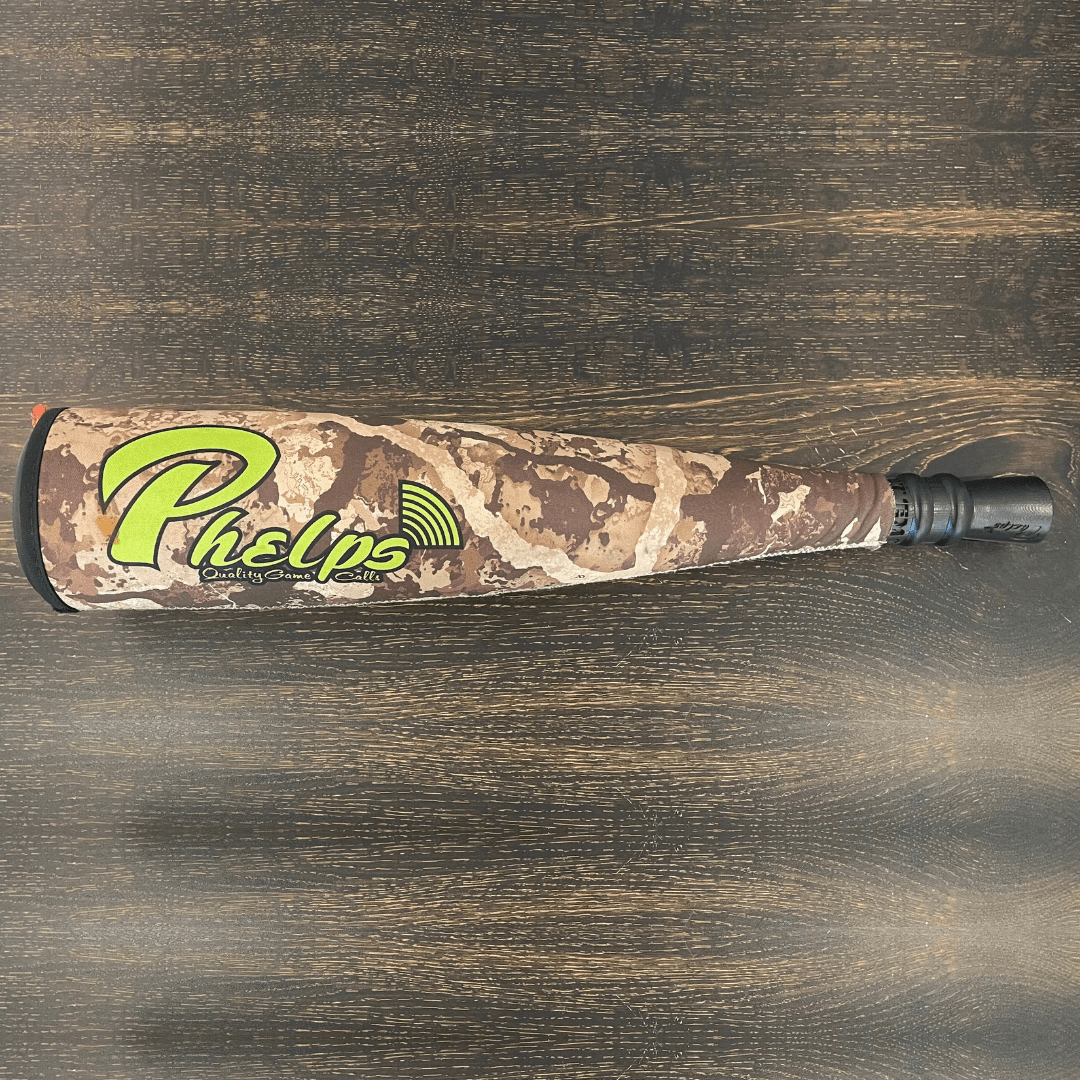 Camo Phelps elk call with green logo, black mouthpiece, and orange end.