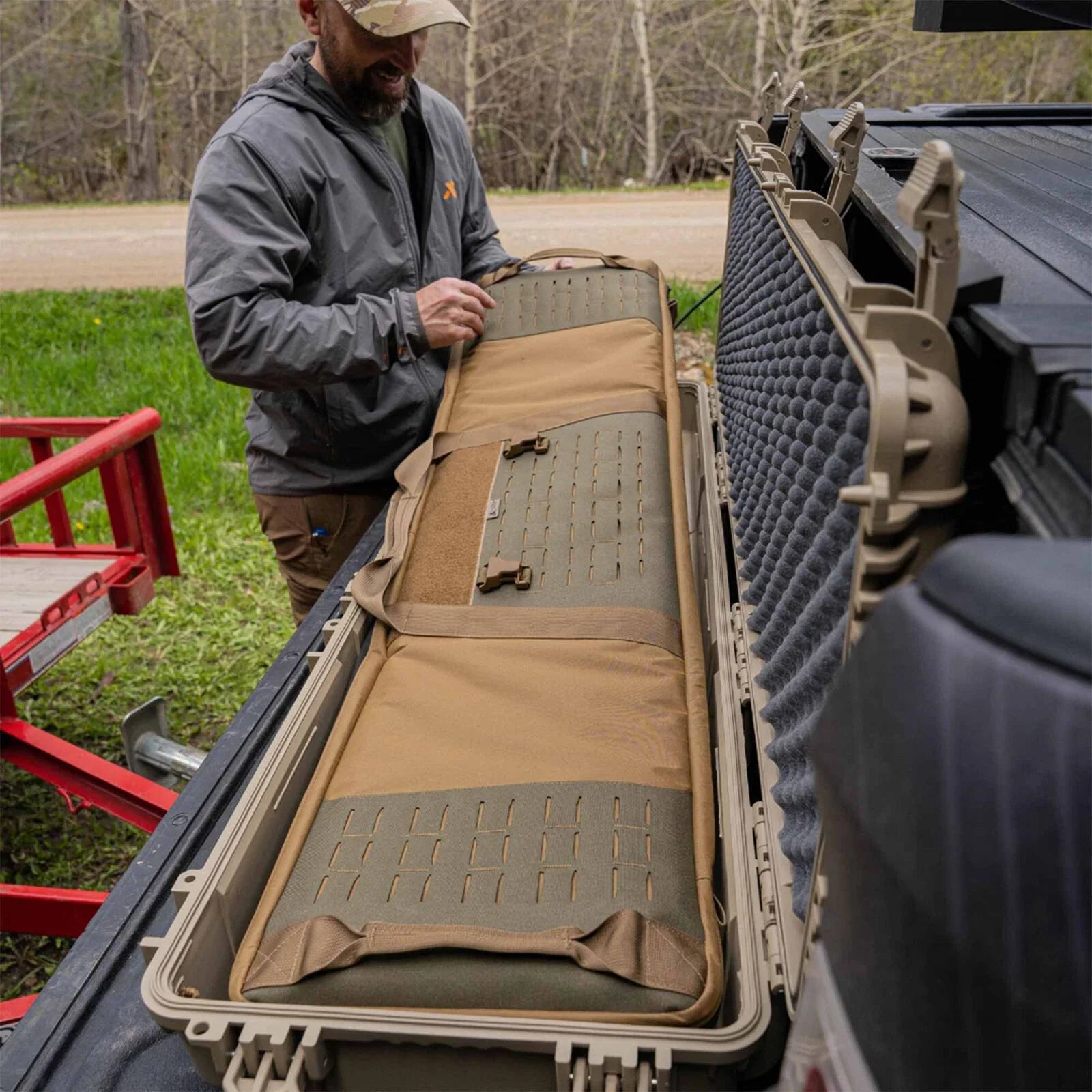 Tan and olive padded rifle insert with MOLLE slots inside a tan hard case.